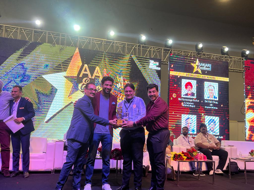 Aakar Excellence Award trophy being presented on stage