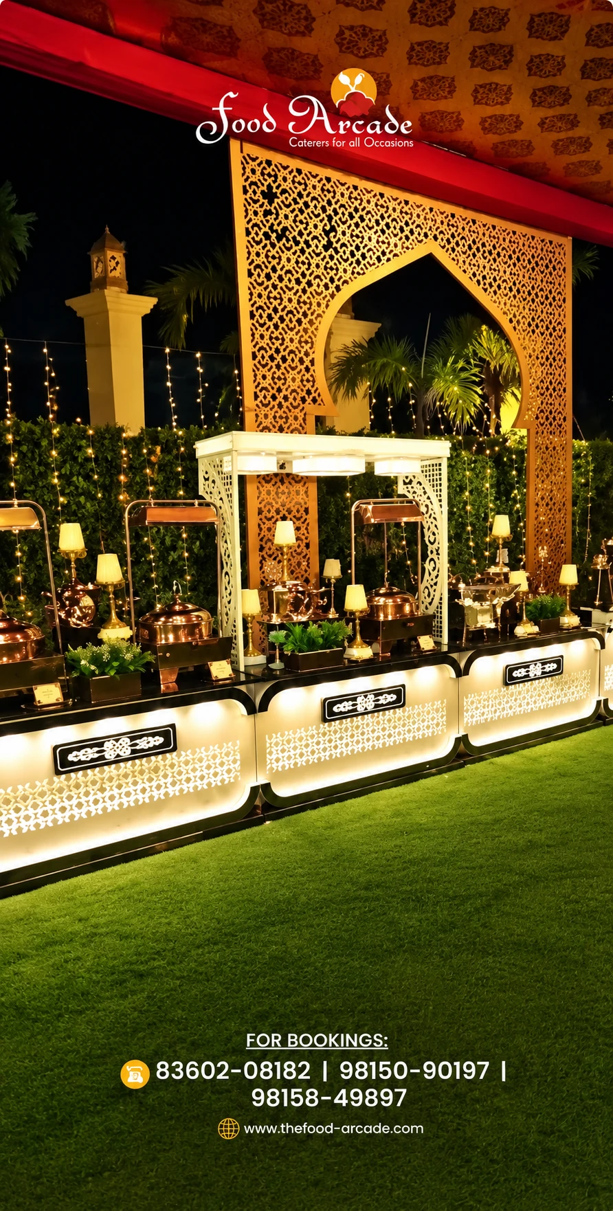 Lit buffet counters with copper serving dishes beneath a carved golden gateway at night